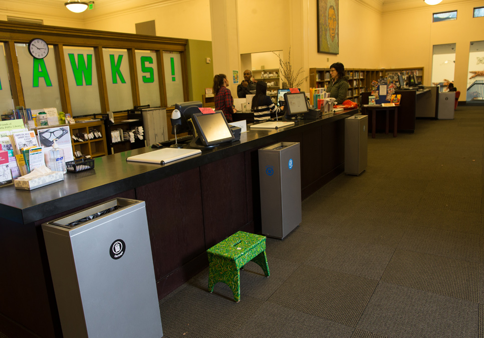 Library staff at the service desk area at the Douglass-Truth Branch