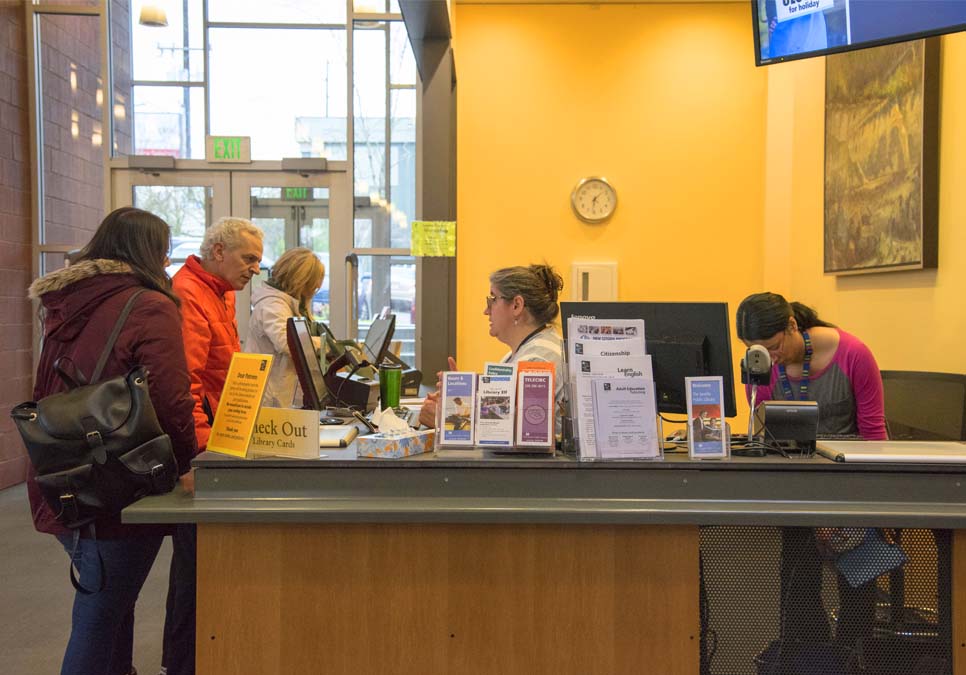 Library patrons at service desk area at the Northgate Branch