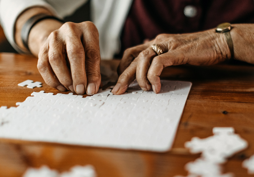 Older person working on a jigsaw puzzle
