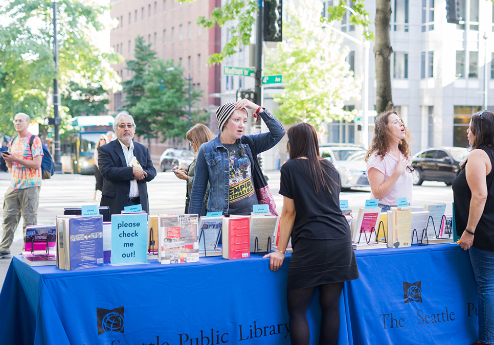 Library staff interacting with patron at art on the plaza event at the Central Library