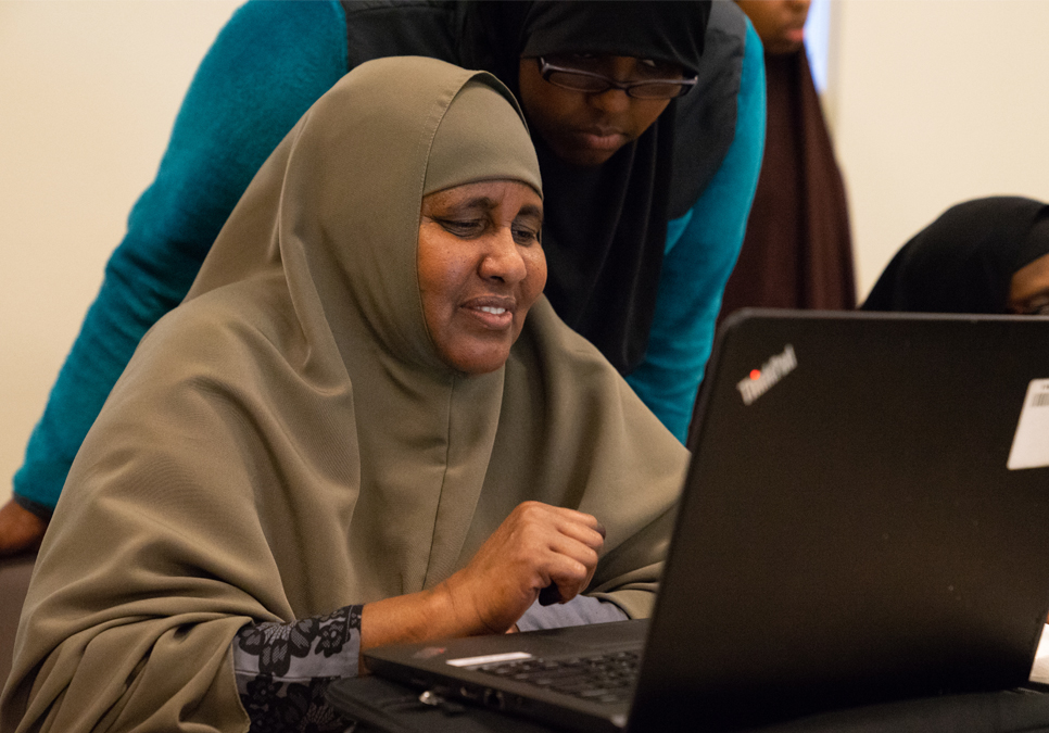 Patron learning how to use a laptop computer at a at NewHolly Branch class for Somali women.